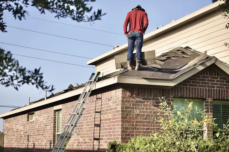 Professional roofer working on a residential roof in Trask Fairview